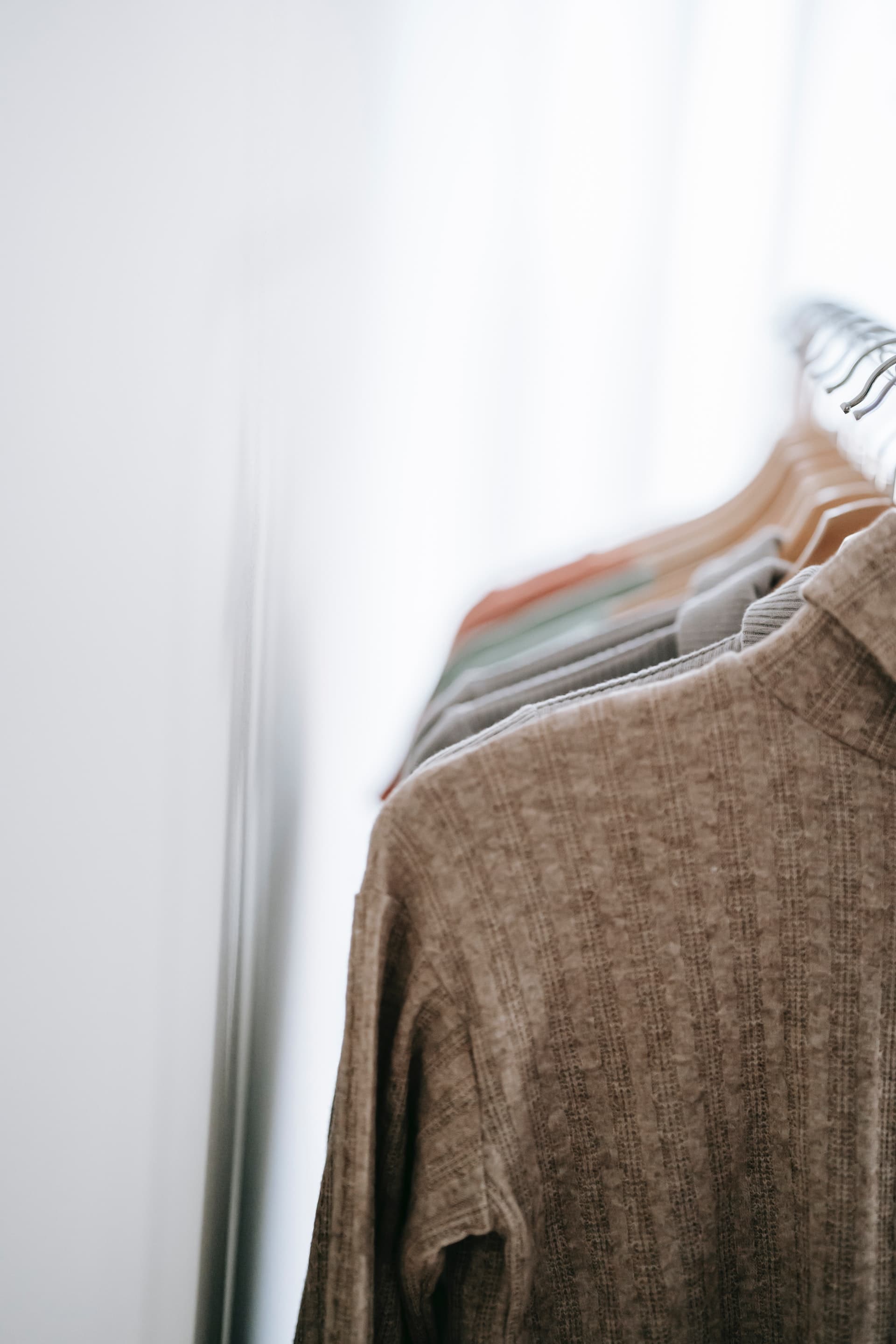 Photo of clothing on hangers by Liza Summer from Pexels